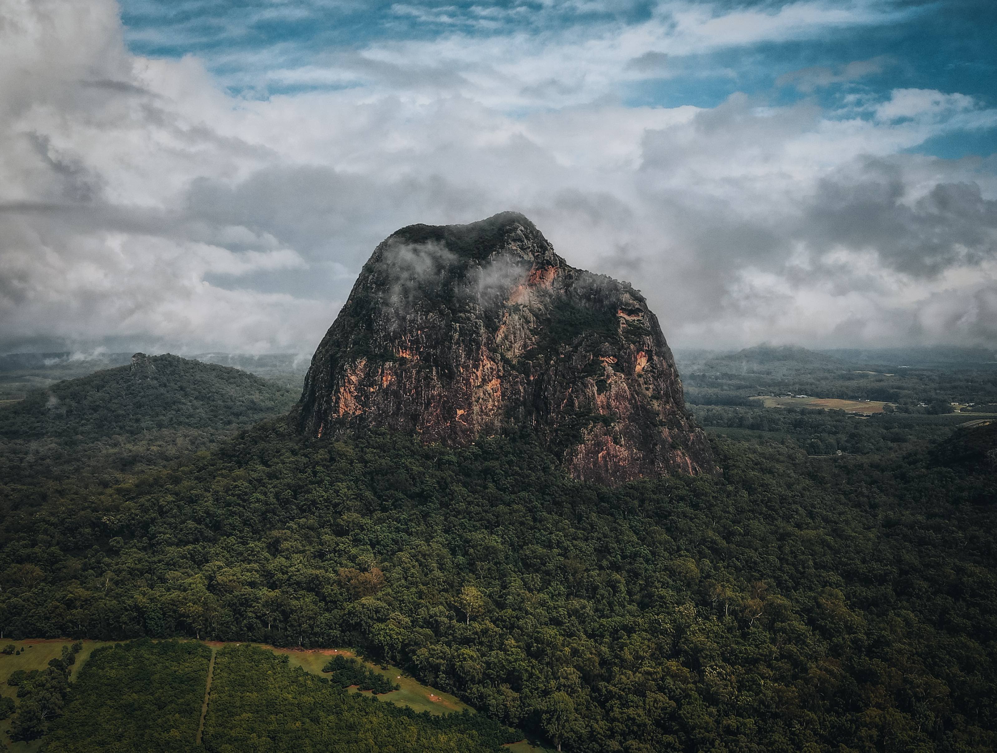 Iconic Glass House Mountains rising majestically in Queensland, offering stunning hiking opportunities amidst nature's grandeur