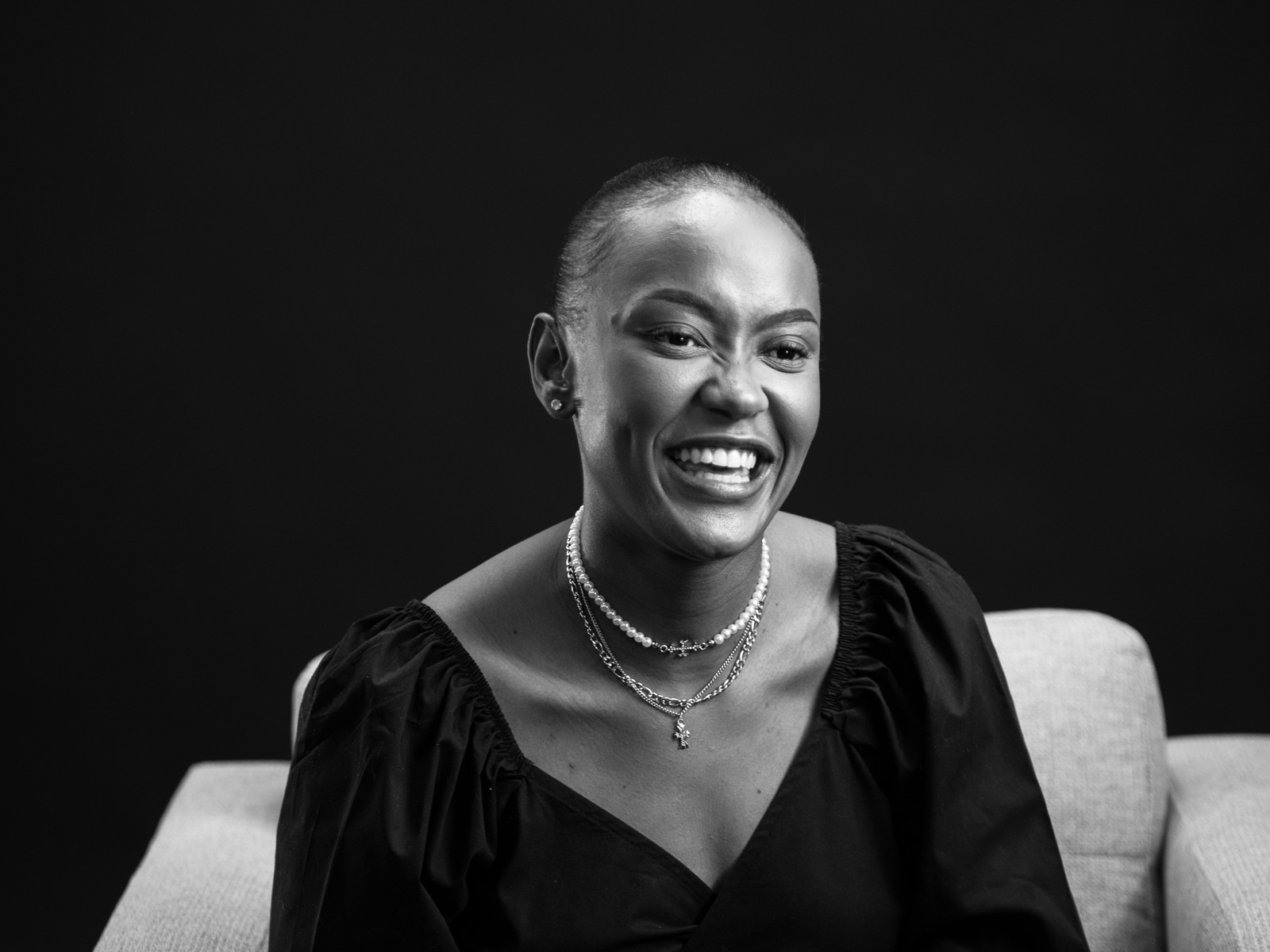 Dimakatso Gama, laughing, seated in an armchair