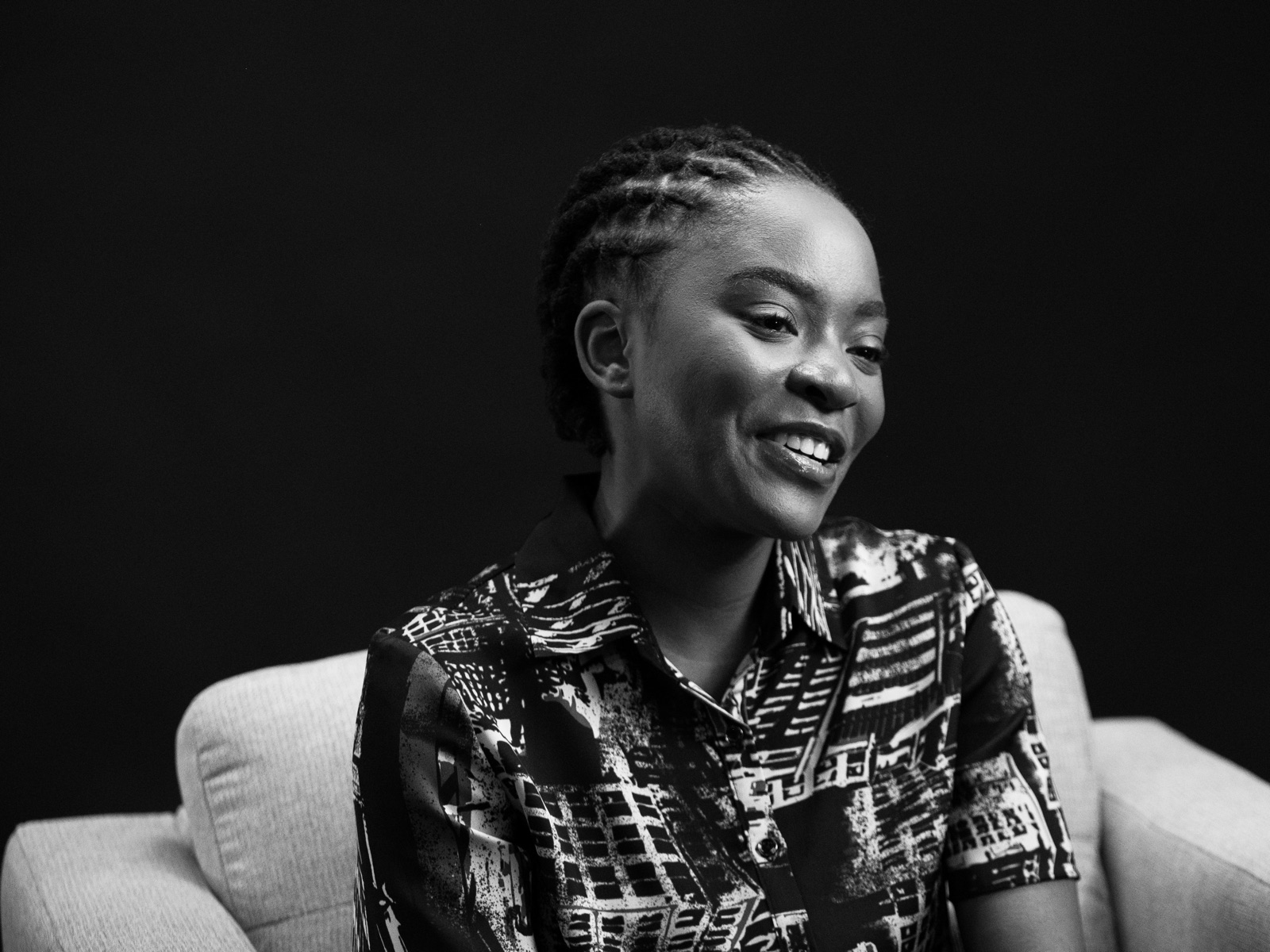Manilla Msulwa, smiling, seated in an armchair