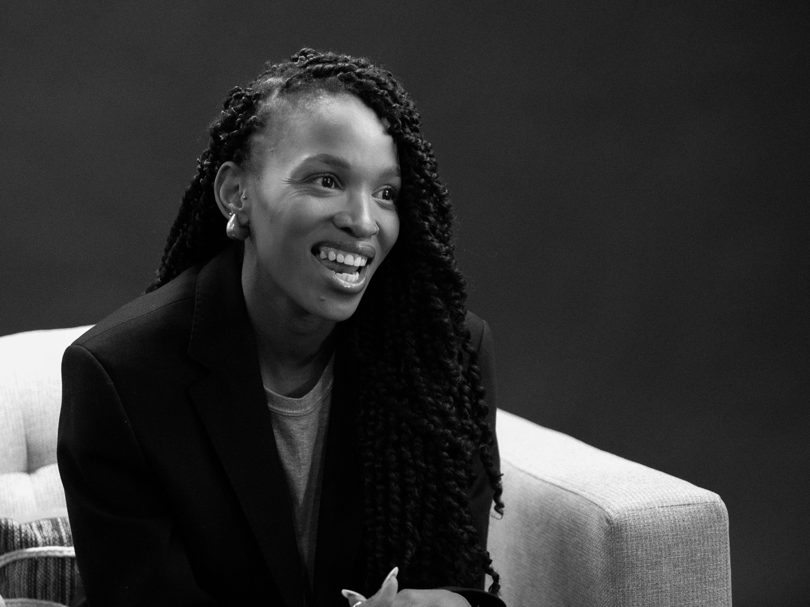 Keitumetsi Magwaza, smiling, seated in an armchair