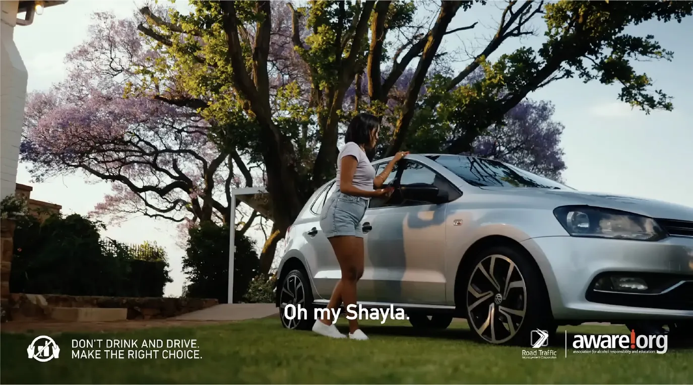 Still from the Shiyi'moto campaign video: a young woman opening the door of a silver car