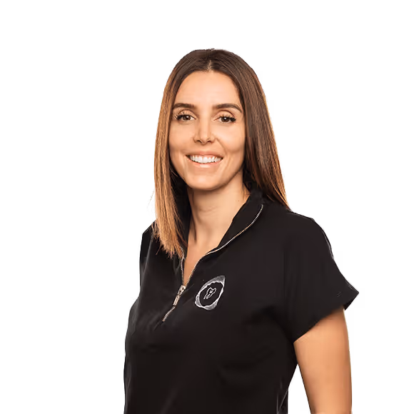 A smiling woman with straight brown hair, wearing a black T-shirt with a tooth-shaped logo on the chest.