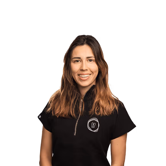 A smiling woman with shoulder-length brown hair, wearing a black dental assistant's uniform featuring a tooth-shaped logo.