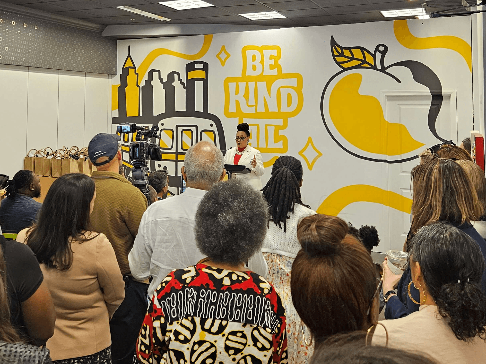 Guests gathered in front of Brianna Gardocki’s BeKindATL mural