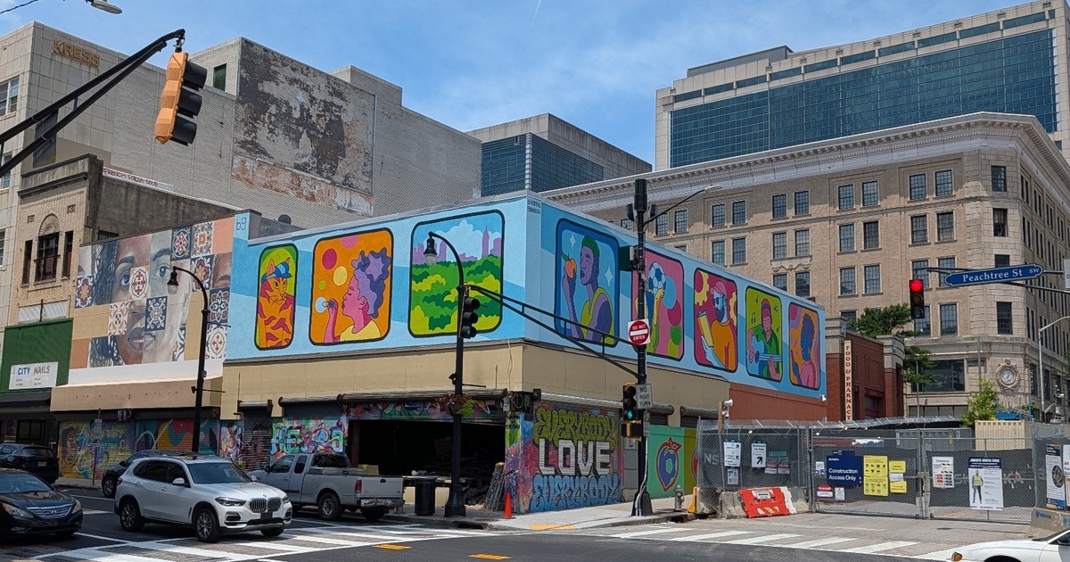 Atlanta in Motion mural featuring colorful scenes viewed through MARTA train windows