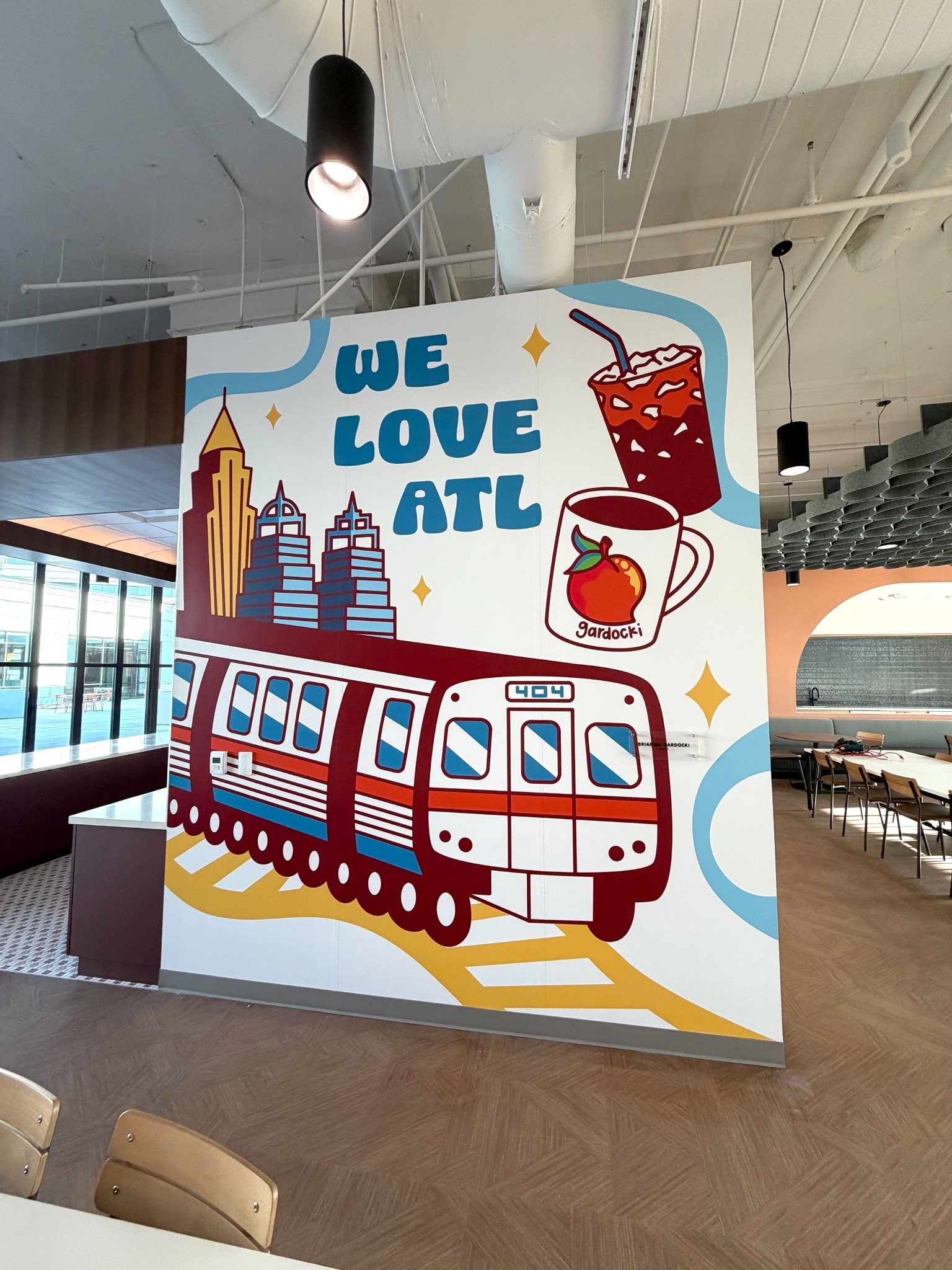 We Love ATL workplace mural at TriNet’s Dunwoody office featuring Atlanta landmarks and a MARTA train