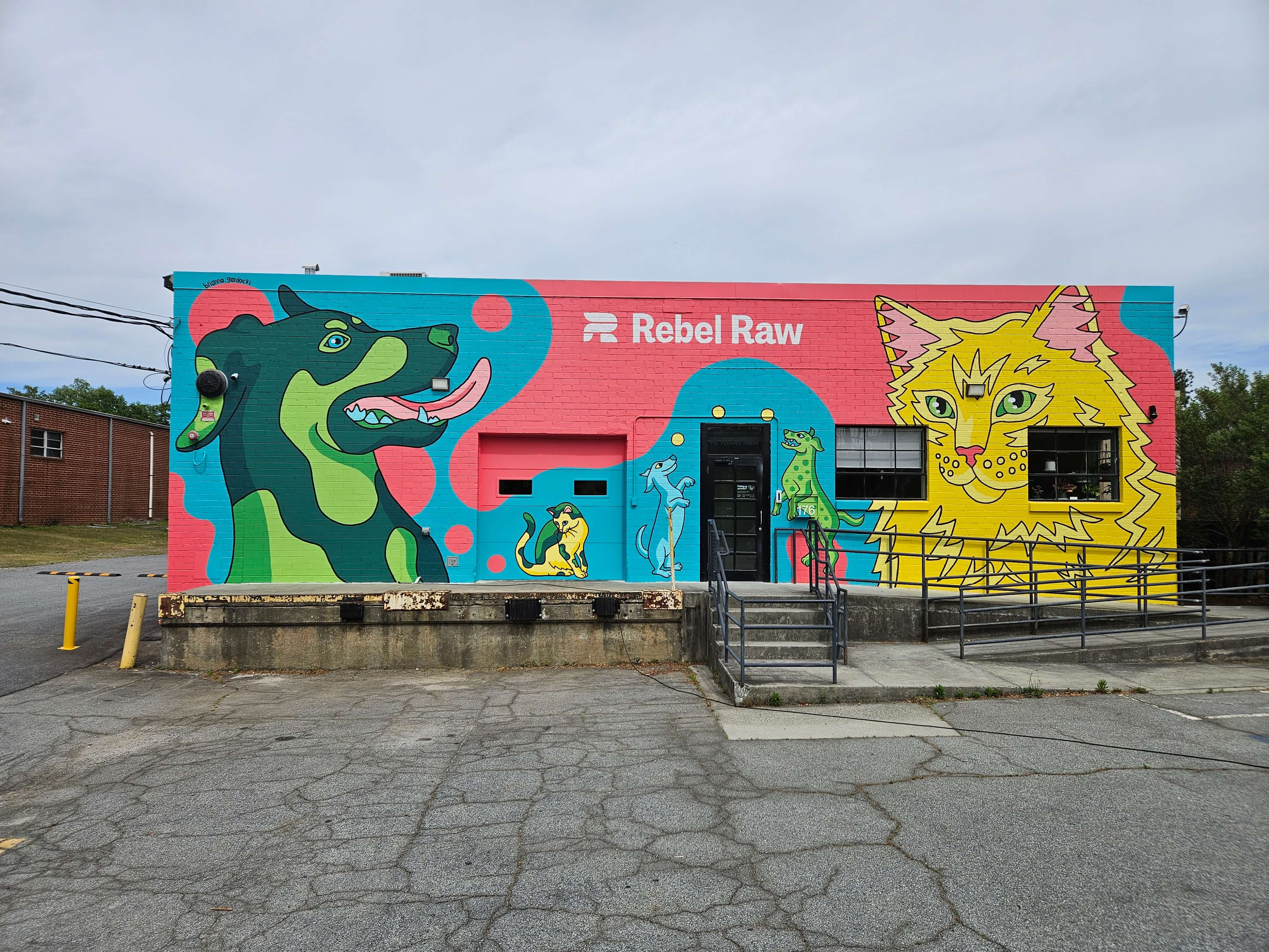 Healthy, Happy Pets mural by Brianna Gardocki on the Rebel Raw brick facade in Atlanta, Georgia