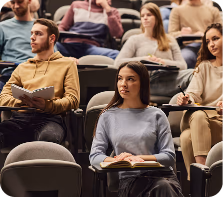 Students listening attentively in a lecture hall or classroom
