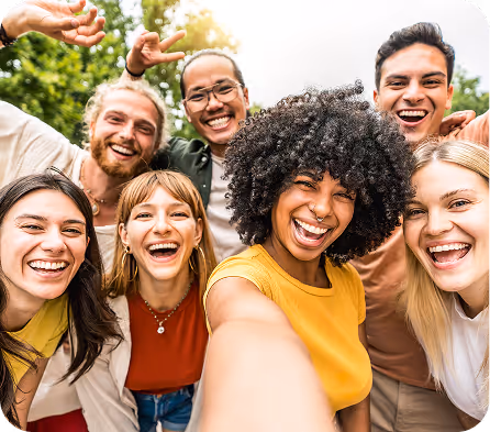 Diverse group of friends laughing and taking a cheerful selfie together