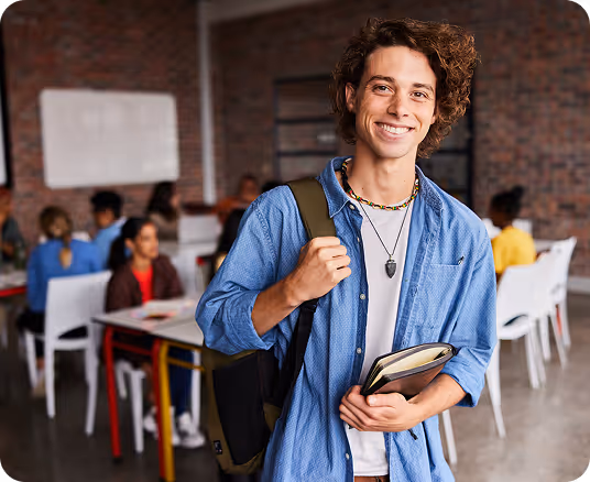 Four female students sitting on outdoor steps, three chatting while one in a green hoodie looks at her phone.