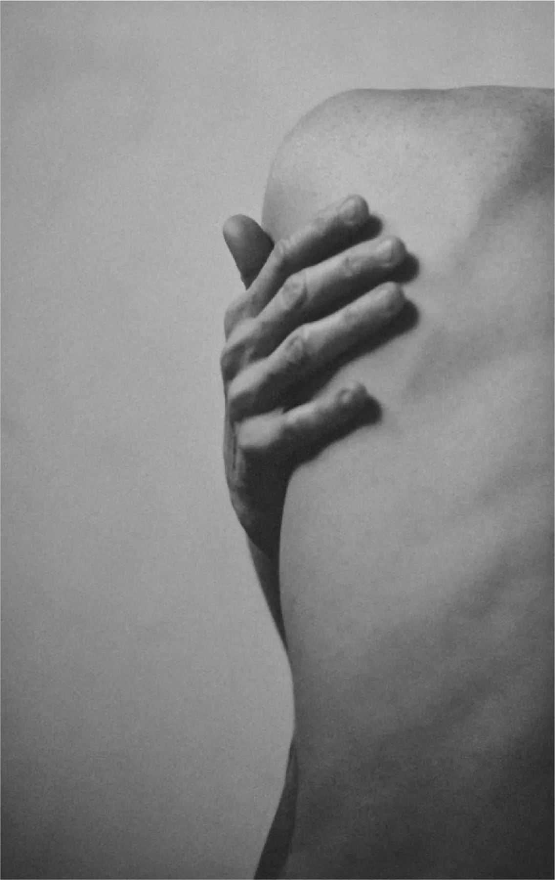 a woman holding her back with her right hand