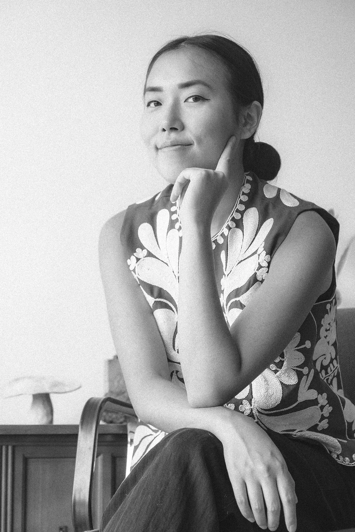 Portrait of a woman sitting on a chair with white background