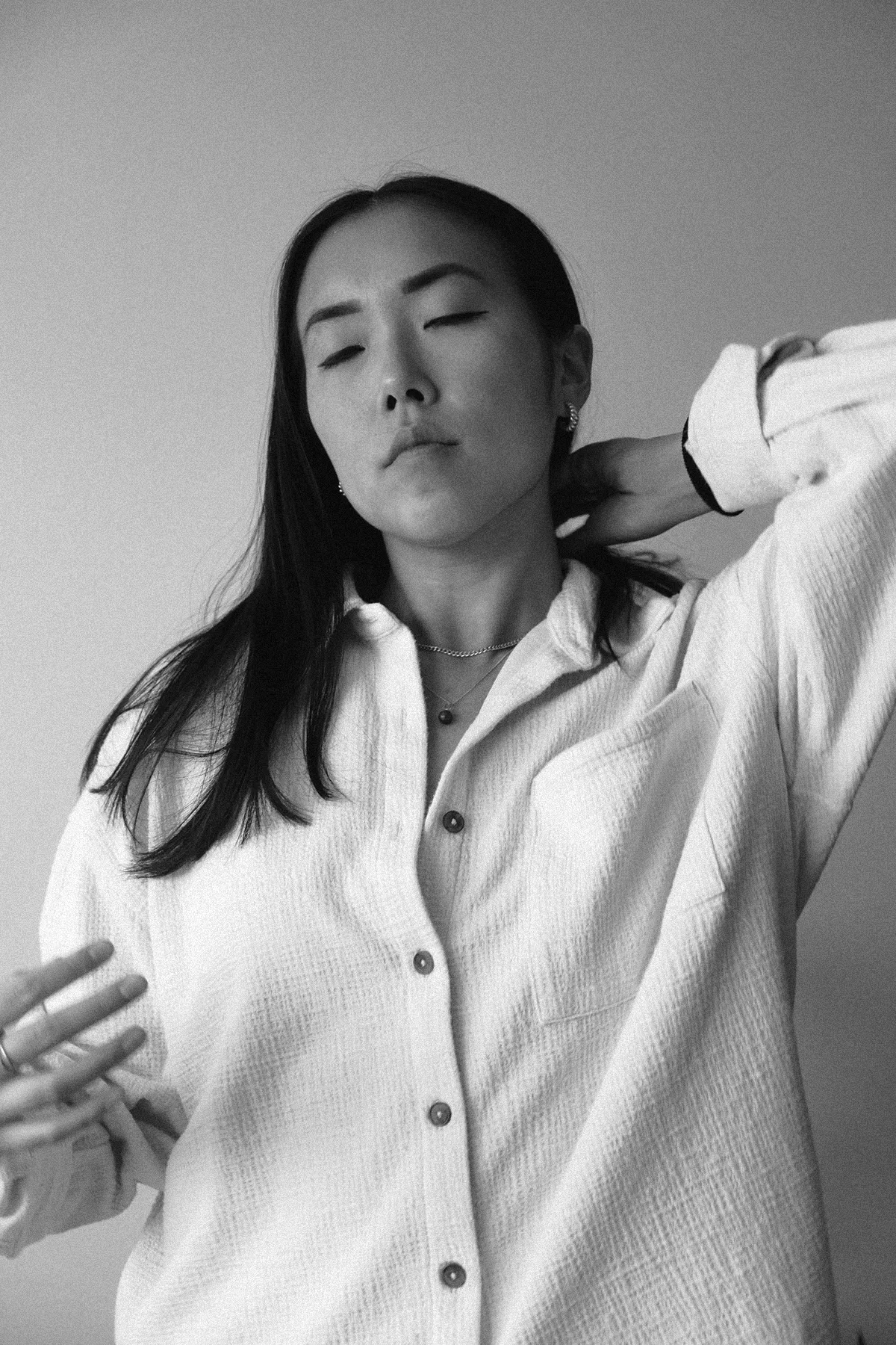 A portrait of a woman holding her hair in her hands 