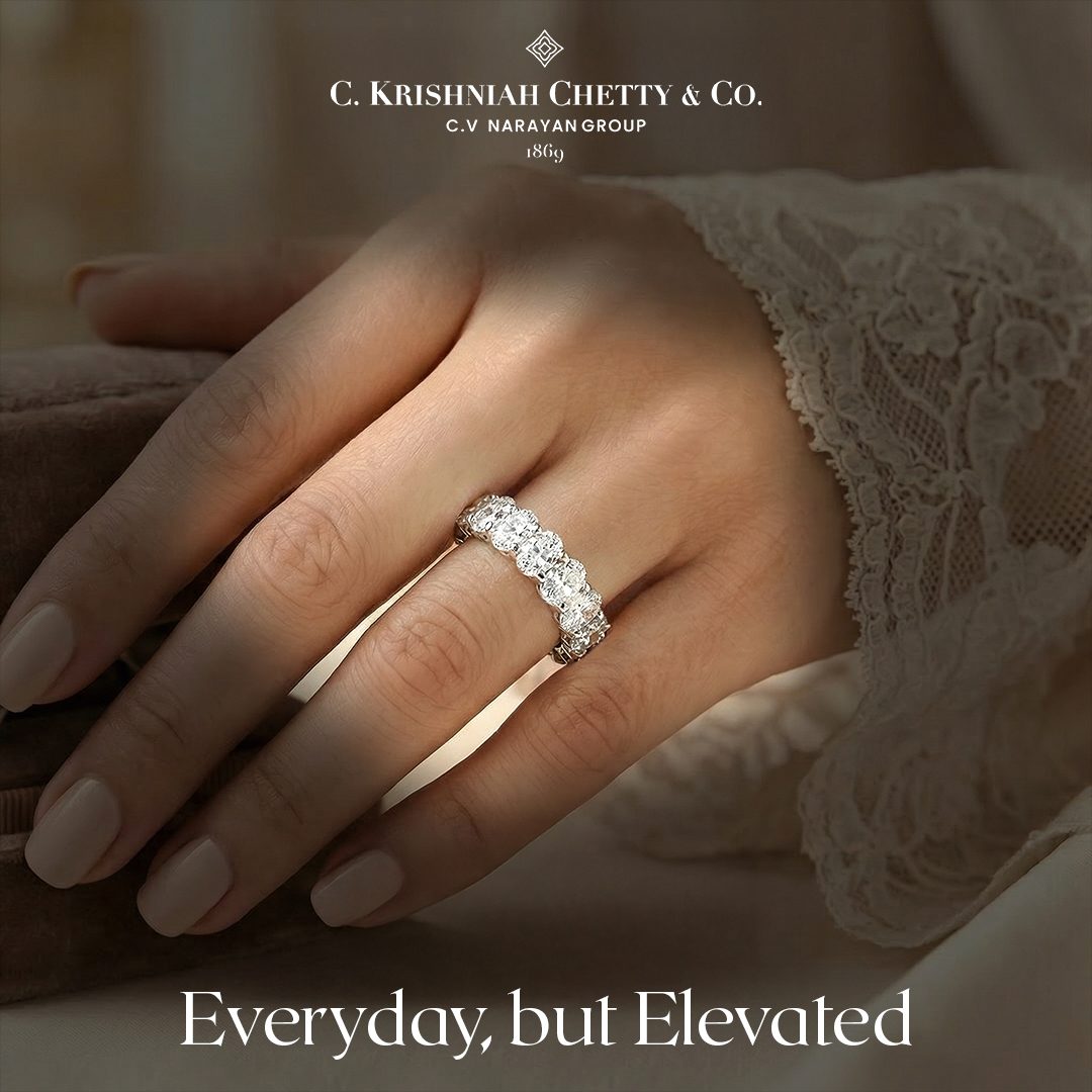 Diamond eternity ring worn on a hand resting against lace, with the line Everyday but Elevated set beneath it