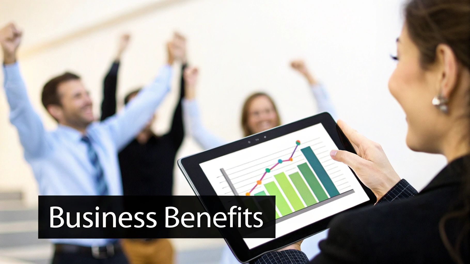 A businesswoman examines a tablet displaying business growth charts as colleagues celebrate success in the background.