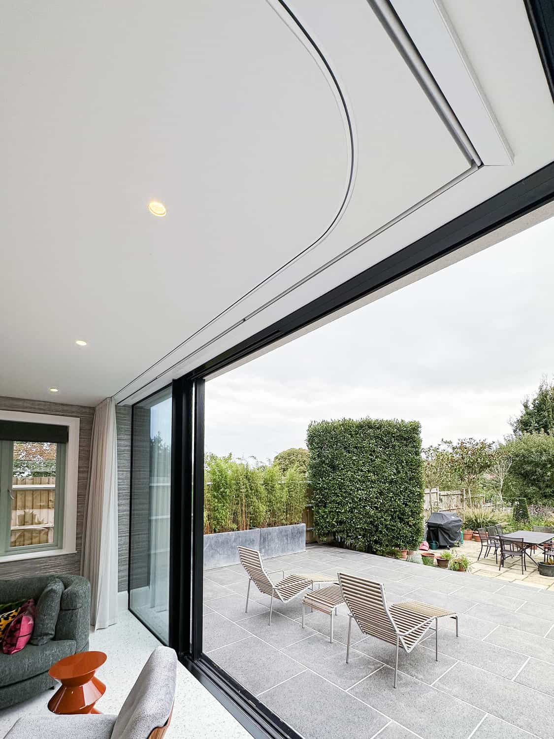 Contemporary bedroom without close up blinds on floor-to-ceiling windows by Grants Blinds