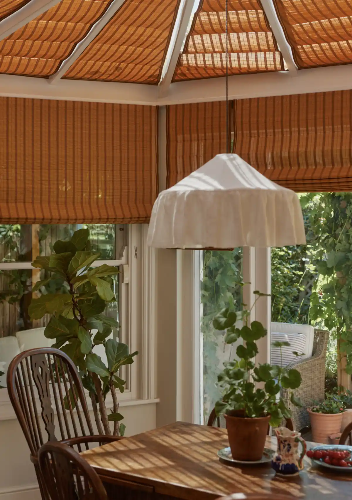 Bamboo Roman blinds across the conservatory roof and windows above the dining table