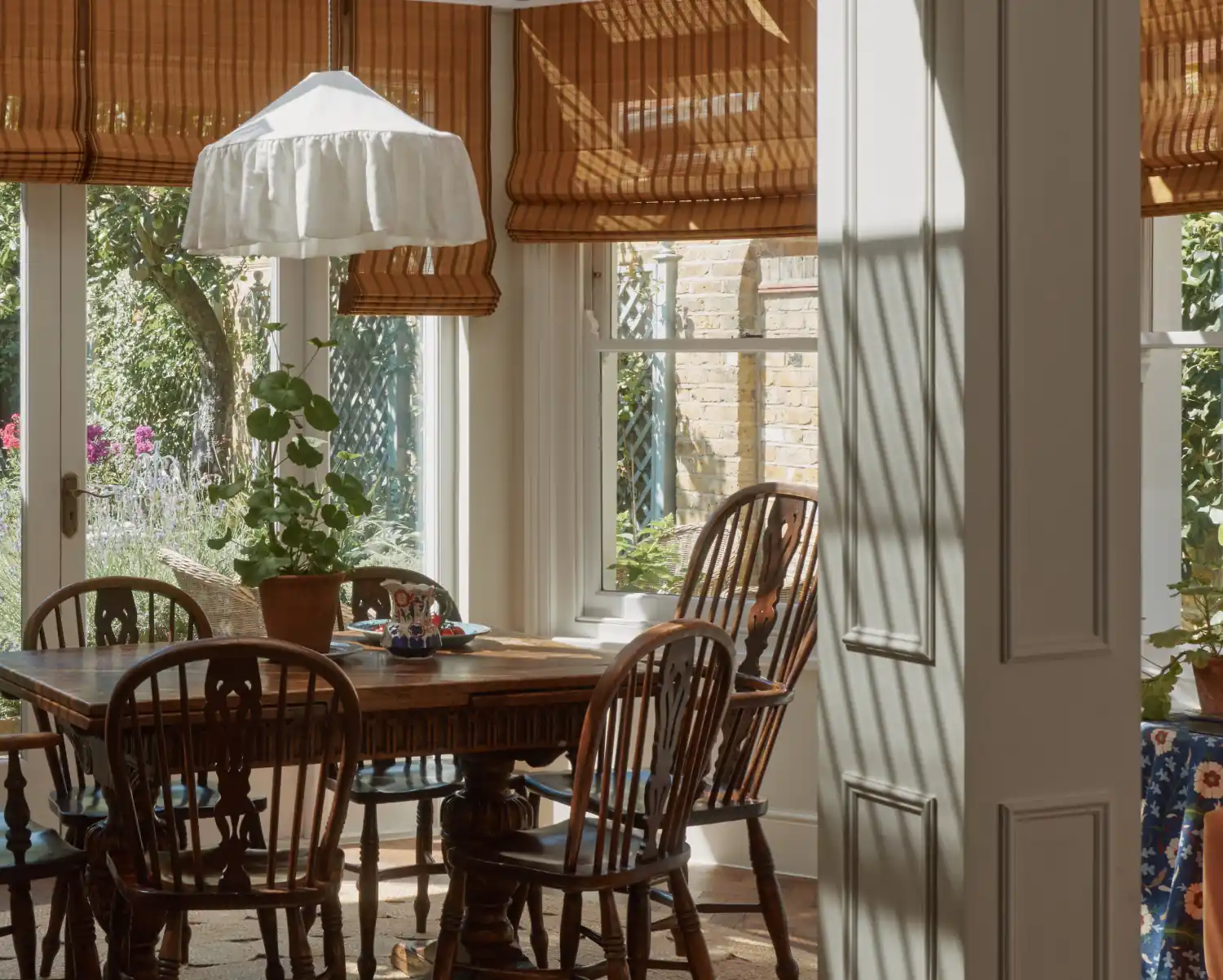 IV Hokkaido bamboo Roman blinds shading the dining area of the London garden room