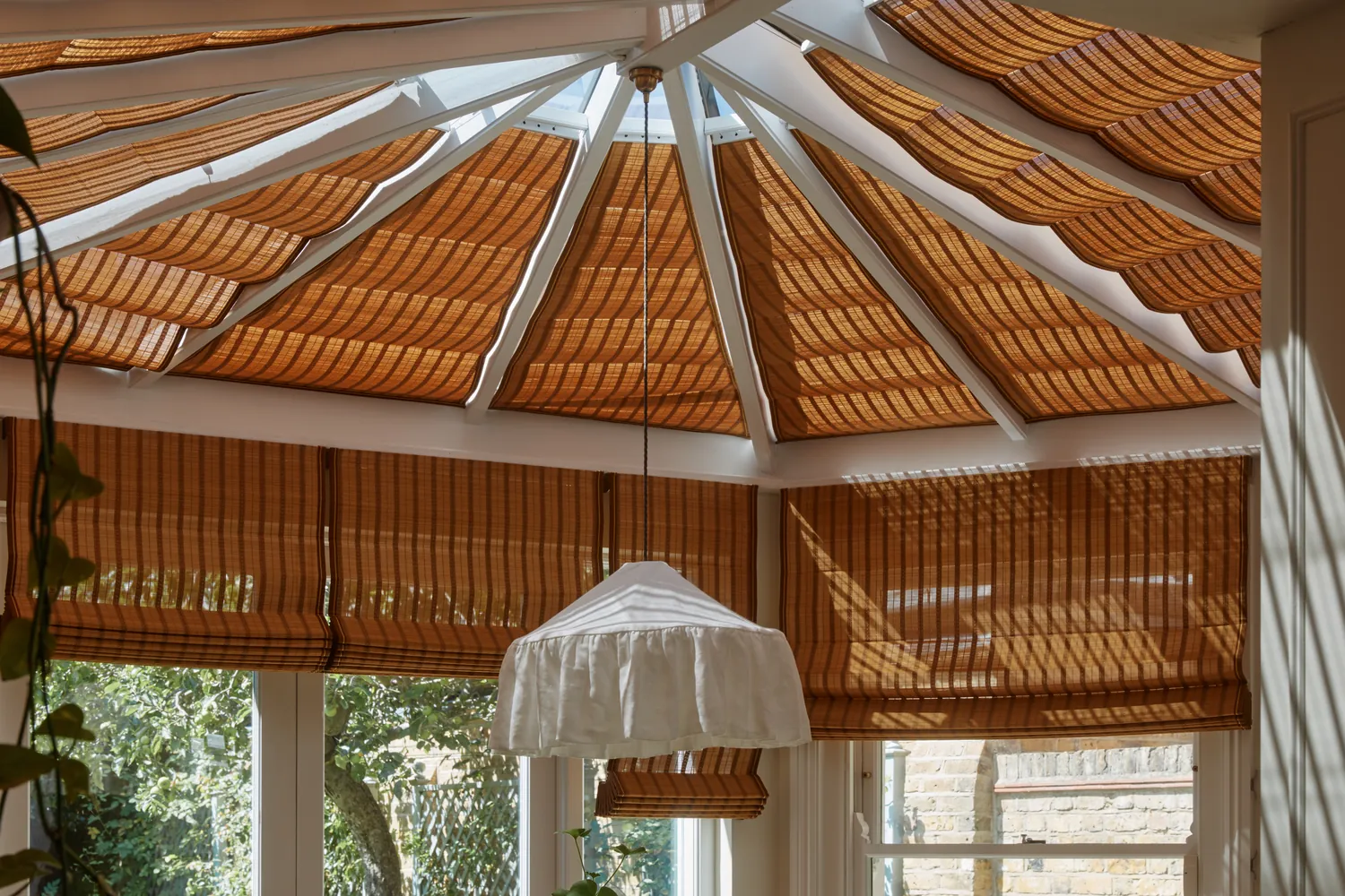 The full span of the octagonal conservatory roof fitted with motorised IV Hokkaido bamboo Roman blinds