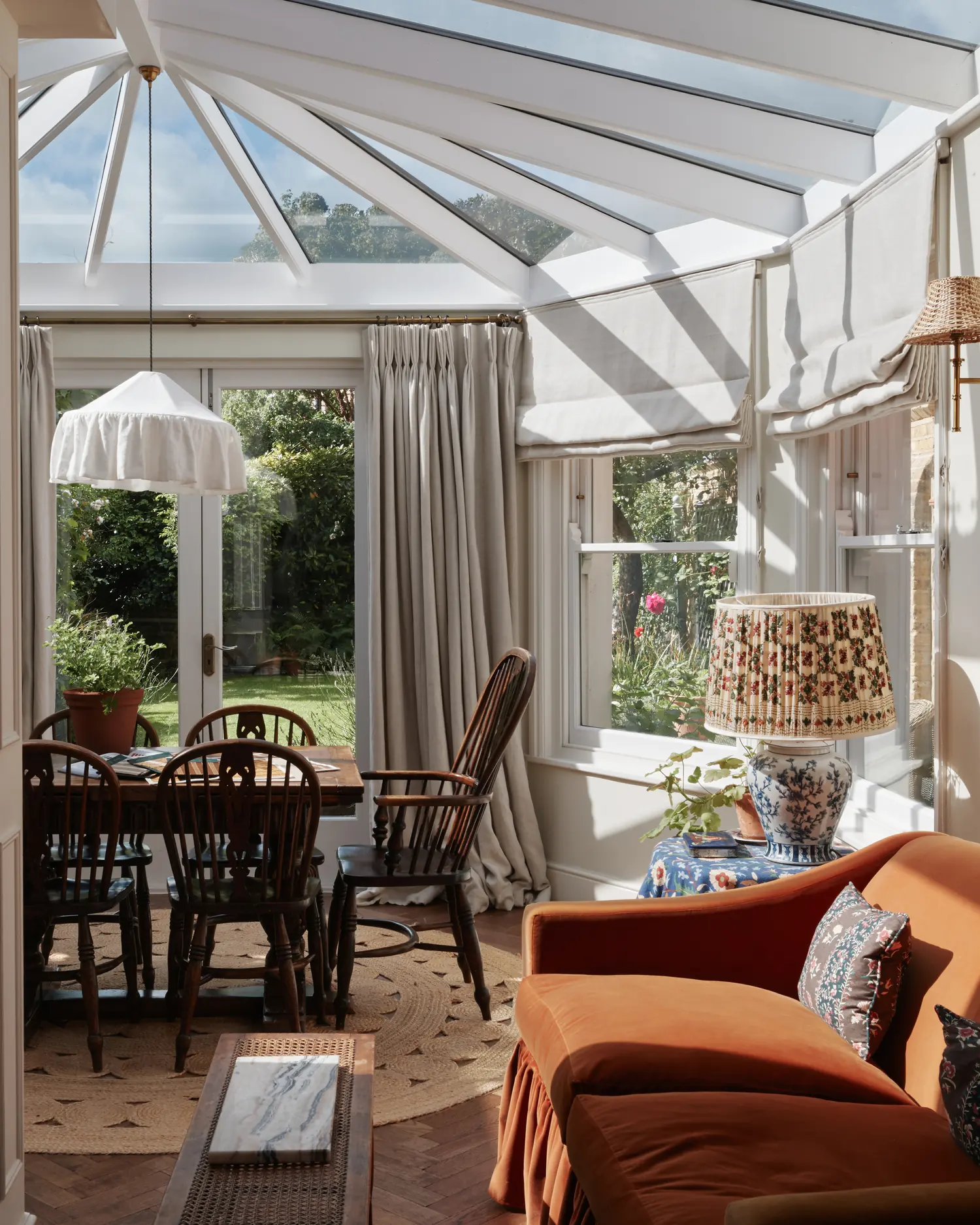 Before the installation: the London conservatory with a bare glazed roof and the original cream Roman blinds