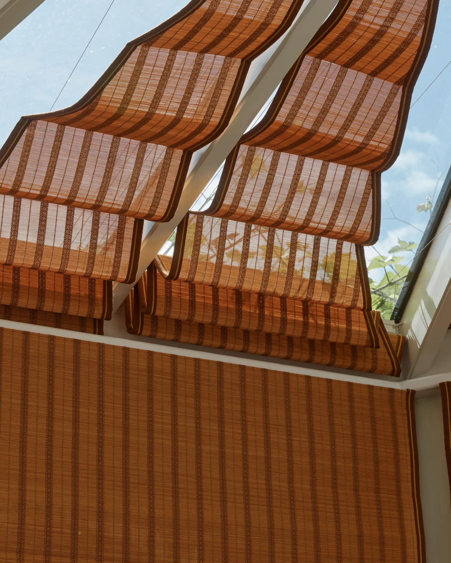 Bamboo roof blinds seen against the sky through the conservatory glazing