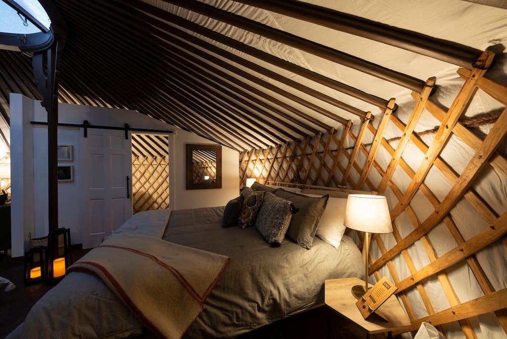 Comfy bed in a grey yurt