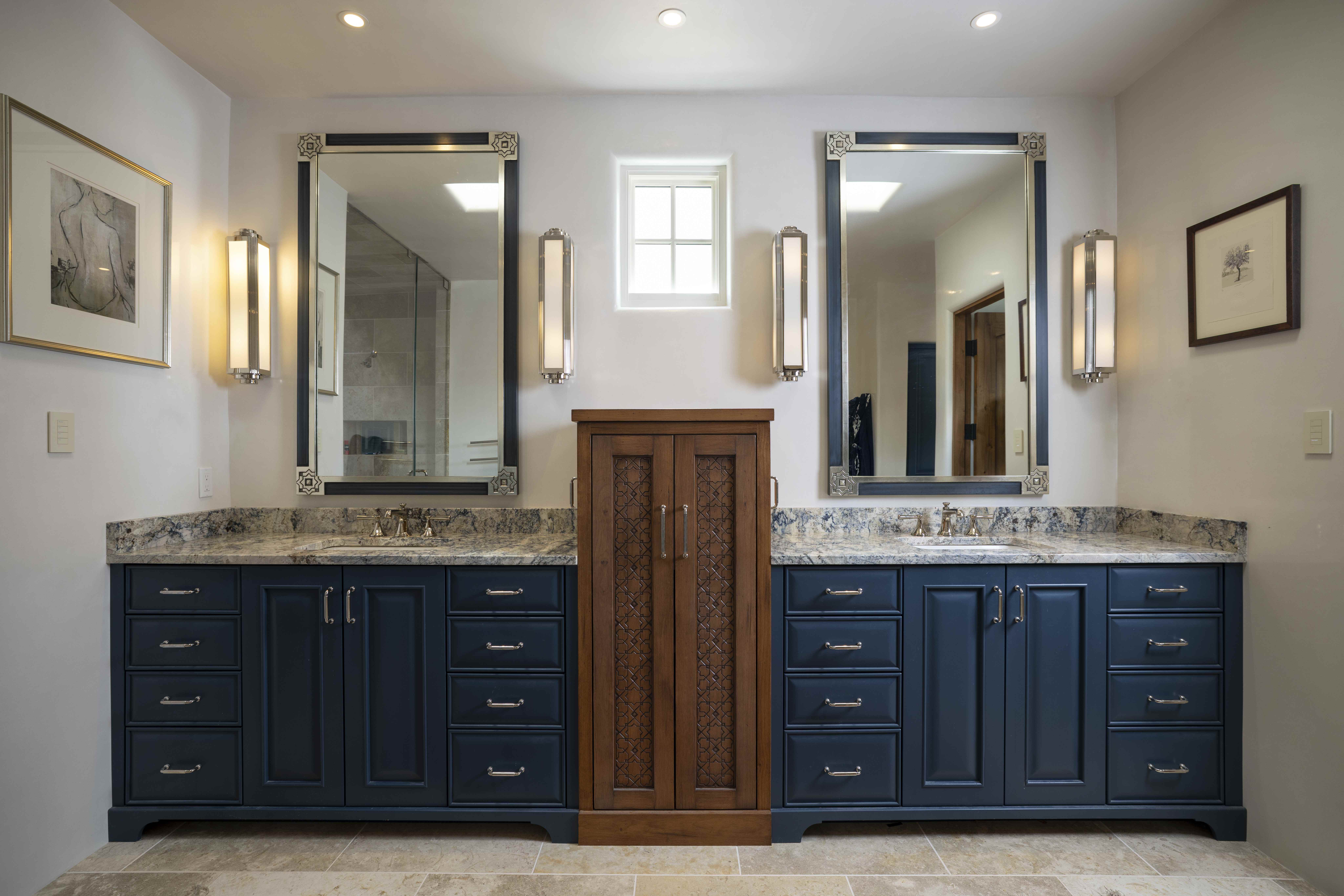 Bathroom with navy double vanity and sconce lighting