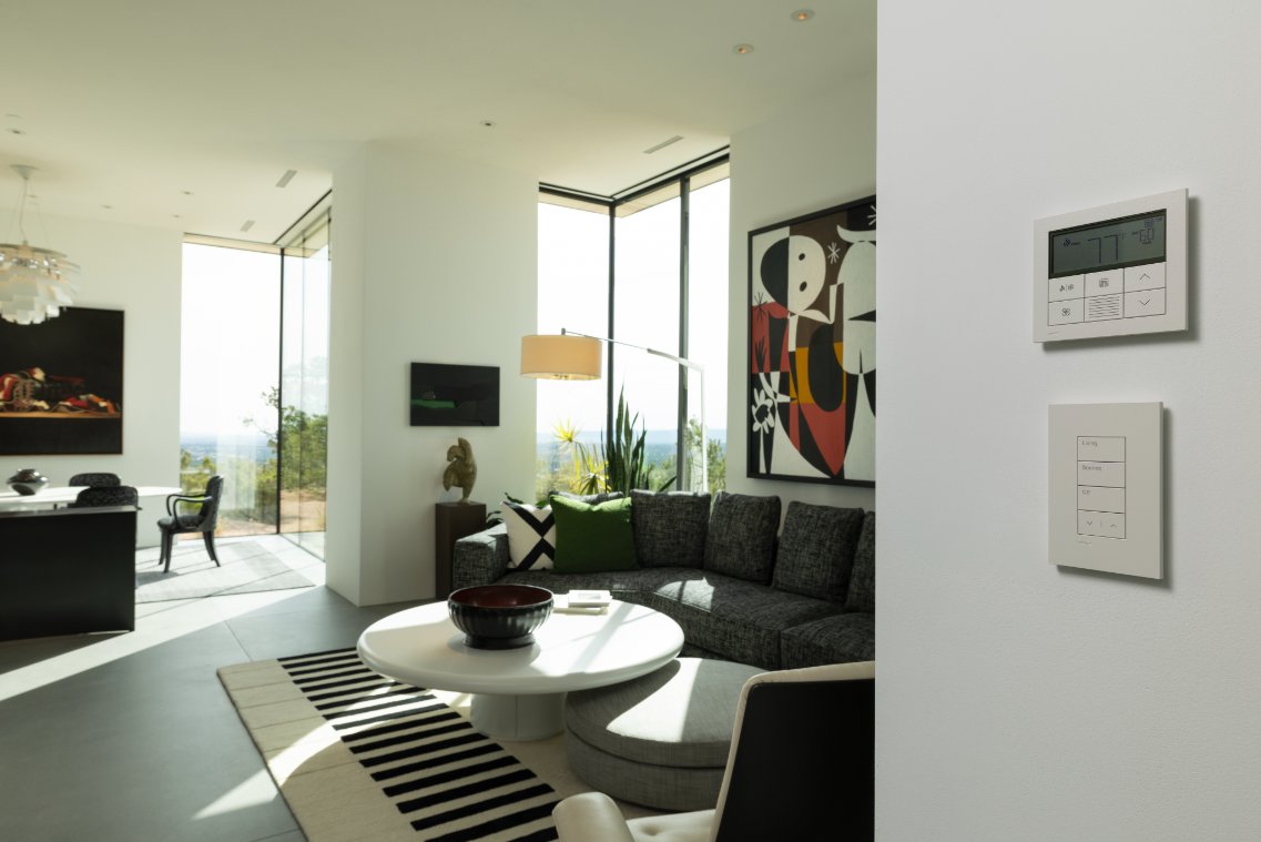Minimal lighting keypads beside a contemporary living room