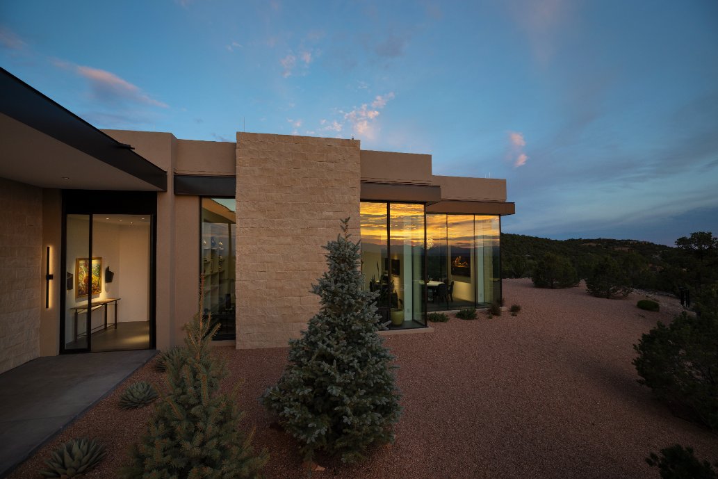 Exterior of a modern Santa Fe home lit at dusk