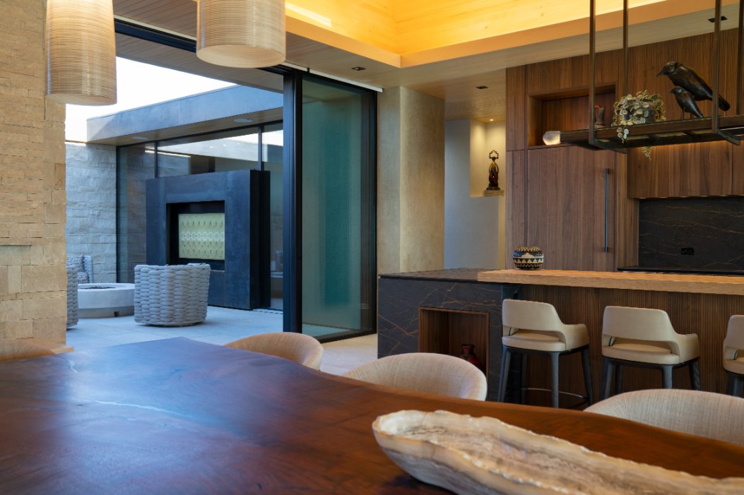 Bar with stools and a TV looking out to the courtyard