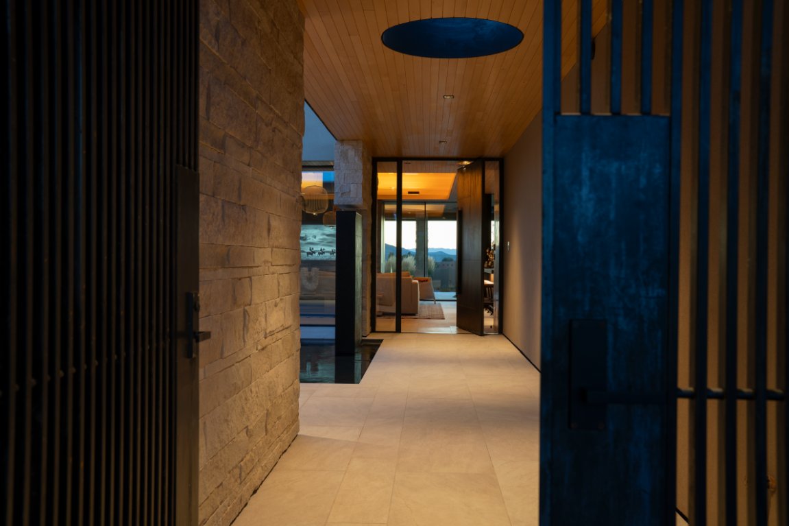 Stone hallway with circular skylight and warm lighting