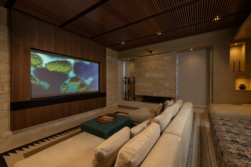 Media room with wall-mounted screen and plush seating