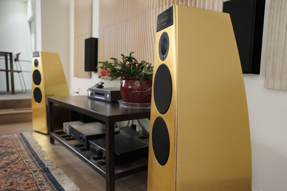 Gold-leafed Meridian speakers in a listening room