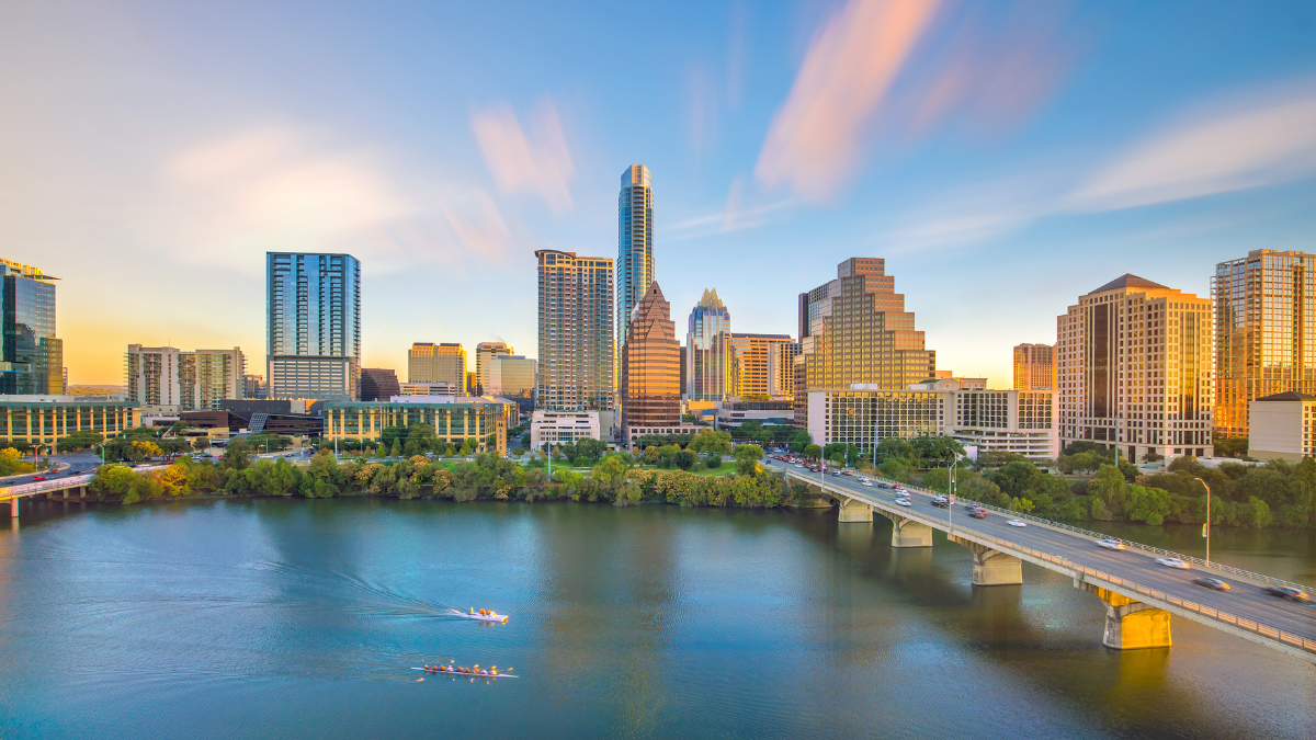 Austin Texas skyline during the day with the bridge going over the river.