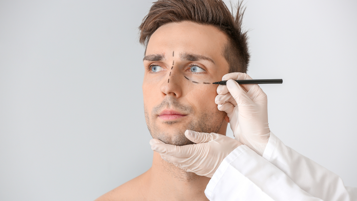 A man getting an outline of incisions prior to a plastic surgery procedure.