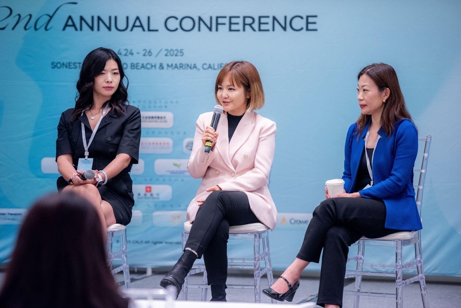 A group of women sitting in chairsAI-generated content may be incorrect.