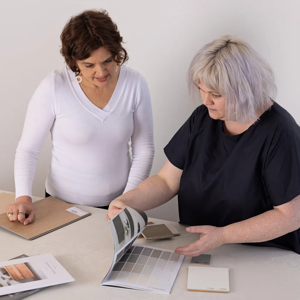 Interior designer and client looking at selections and finishes