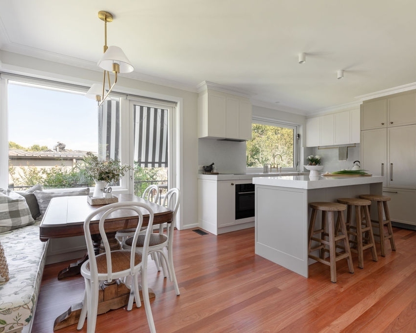 Modern home interior of dining and living areas including custom joinery and timber flooring