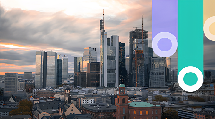 City skyline at sunset with modern skyscrapers and some older buildings in the foreground, under a partly cloudy sky with warm tones.