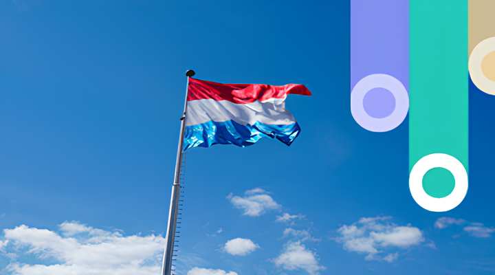 Luxembourg flag with red, white, and blue horizontal stripes waving on a pole against a clear blue sky with scattered clouds.