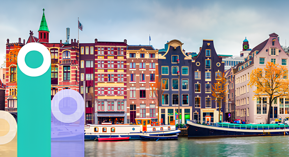 Colorful historic buildings with distinct gabled facades along a canal in Amsterdam, with boats moored in the water and a cloudy sky above.