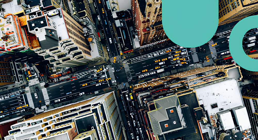 Aerial view of a busy city intersection with multiple roads, tall buildings, and numerous yellow taxi cabs.