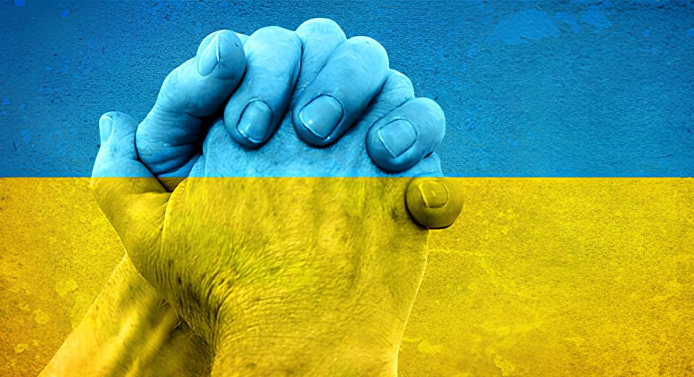 Two hands clasped together in a firm grip with the Ukrainian flag's blue and yellow colors overlaying the image.