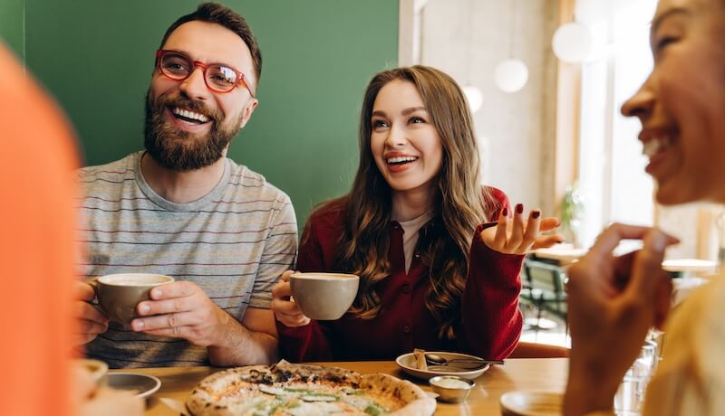 Man and two women enjoying pizza after ADHD therapy with ADHD Success