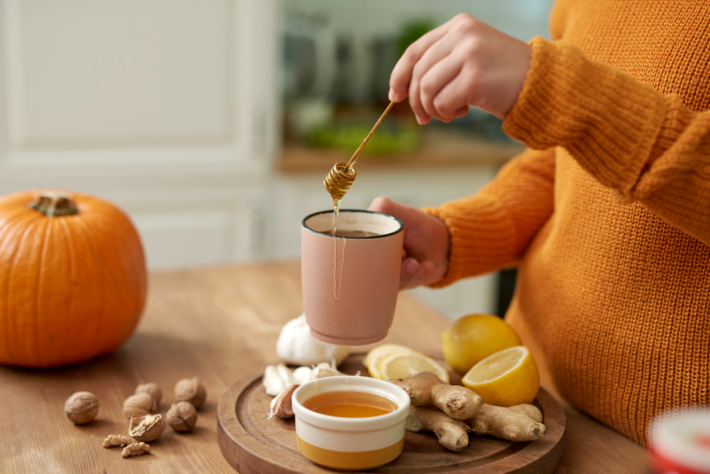 Preparing a warm home remedy with honey, ginger, and lemon to soothe a swollen uvula naturally