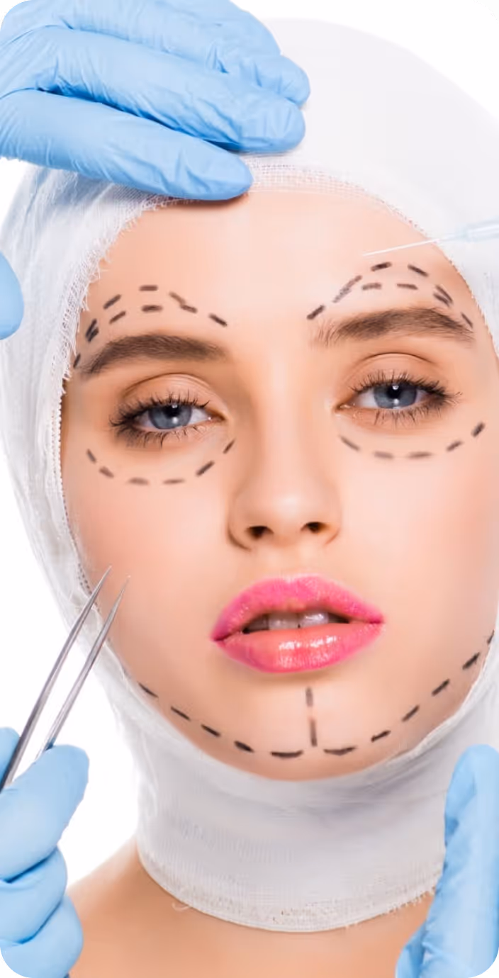Male doctor wearing glasses and a white coat with a stethoscope around his neck, sitting at a desk with hands clasped.
