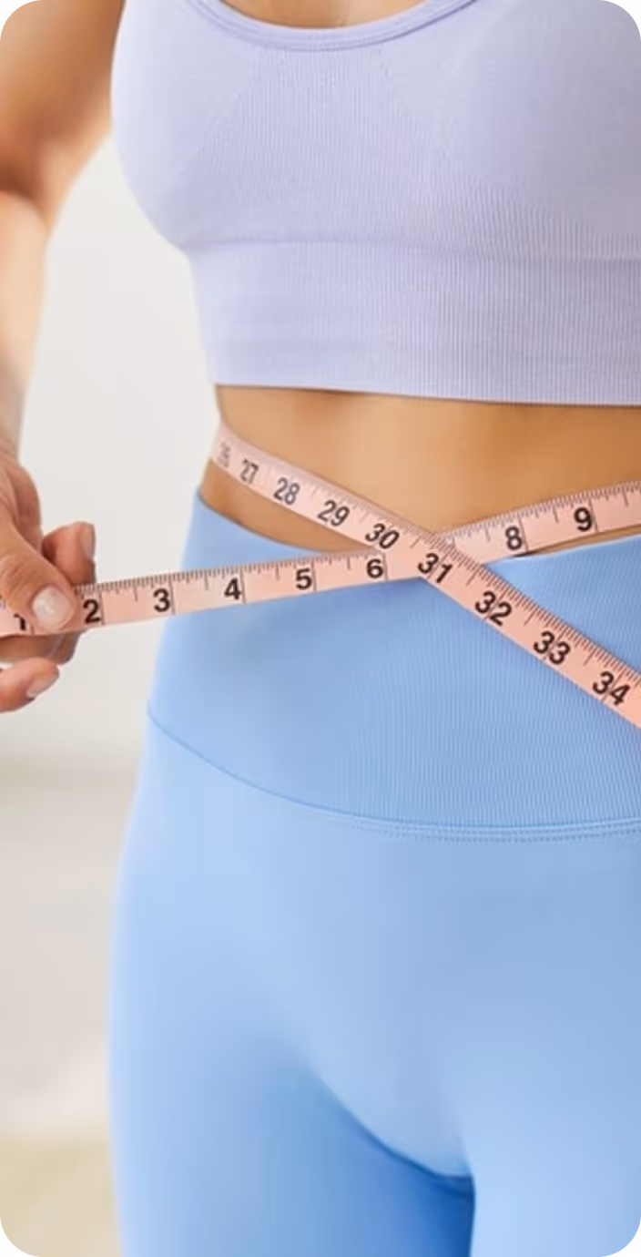 Hands with red nail polish typing on a laptop keyboard with a stethoscope resting on the table beside the laptop.