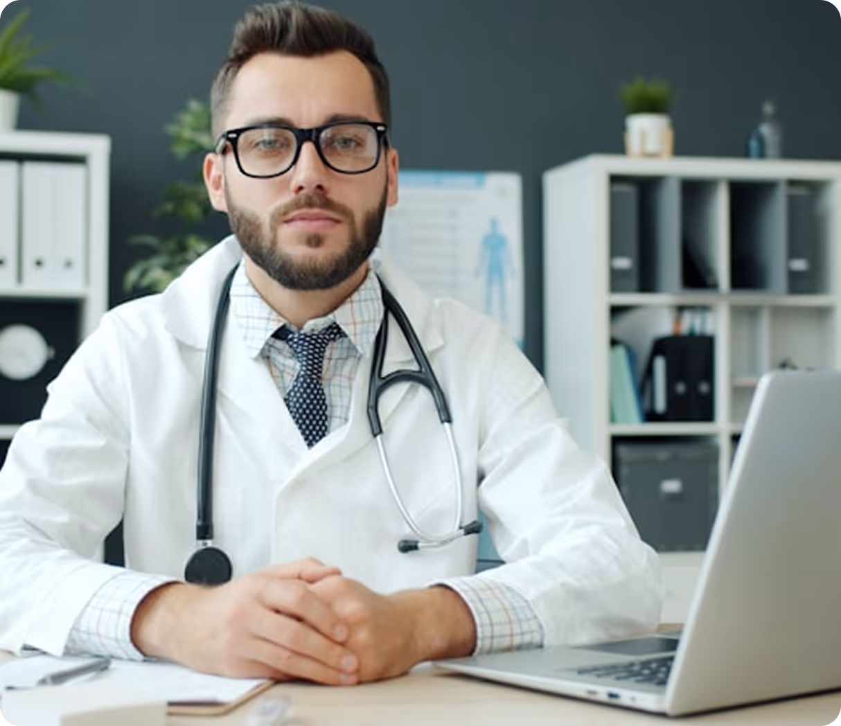 Group of medical professionals in lab coats discussing with tablets and charts, smiling and collaborating.