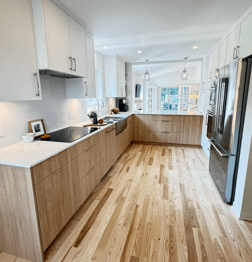 Galley kitchen renovation with light wood cabinets, white counters, and hardwood floors in Ottawa