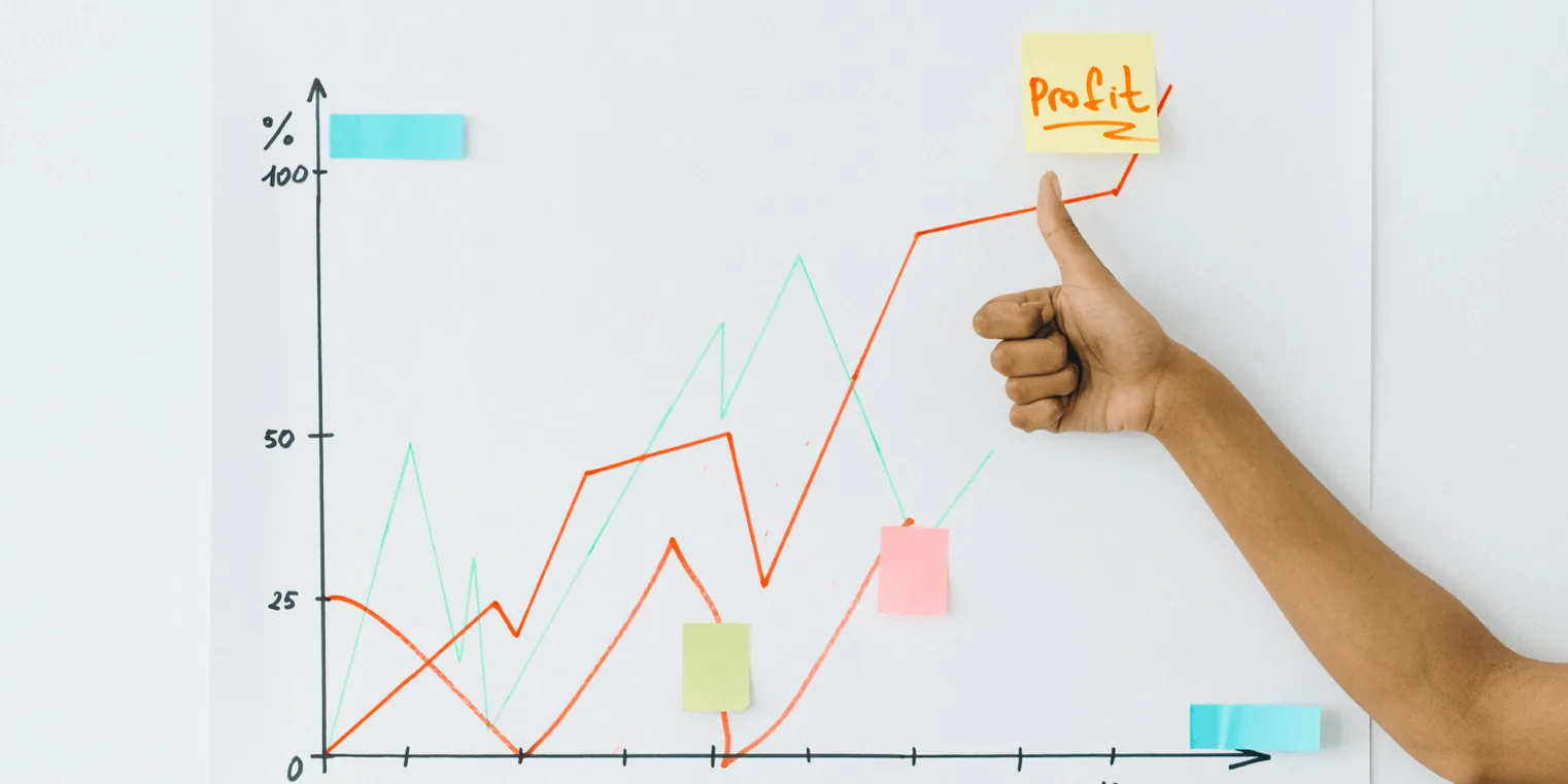 A picture of a line graph that shows how much profit is being made. Someone raises their thumb